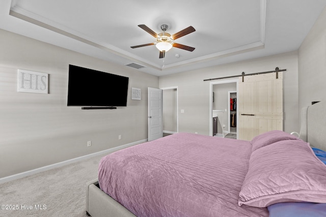 carpeted bedroom with visible vents, baseboards, a barn door, a raised ceiling, and ceiling fan