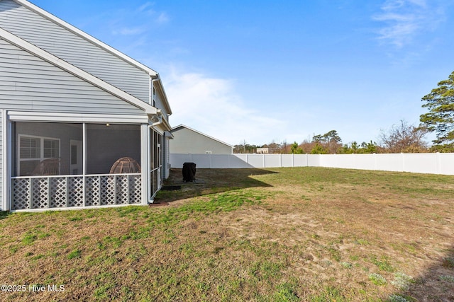 view of yard featuring a fenced backyard and a sunroom