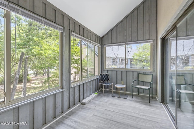 unfurnished sunroom featuring lofted ceiling