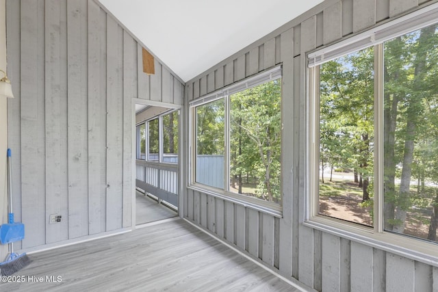 unfurnished sunroom with lofted ceiling