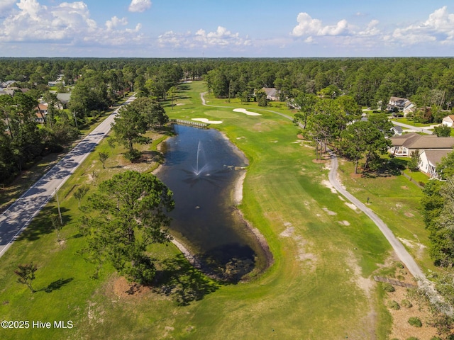 drone / aerial view with view of golf course and a wooded view