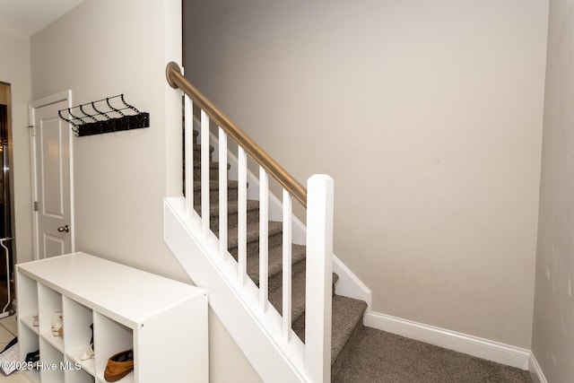 stairway with carpet and baseboards