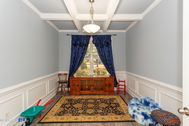 dining area featuring a decorative wall, coffered ceiling, beamed ceiling, and wainscoting