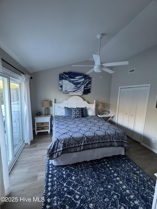 bedroom featuring visible vents, vaulted ceiling, and wood finished floors