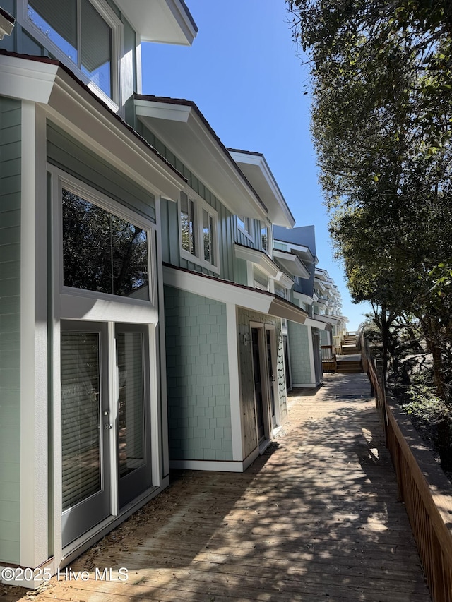 view of home's exterior featuring concrete block siding and french doors