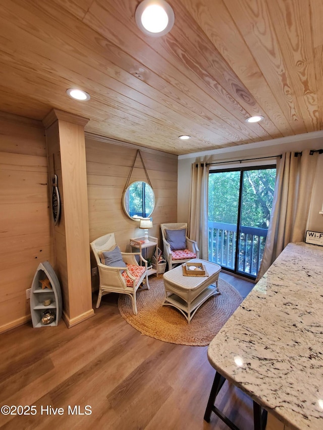 sitting room featuring wood ceiling, wooden walls, wood finished floors, and recessed lighting