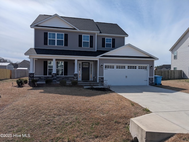 craftsman inspired home with a porch, a garage, fence, stone siding, and concrete driveway