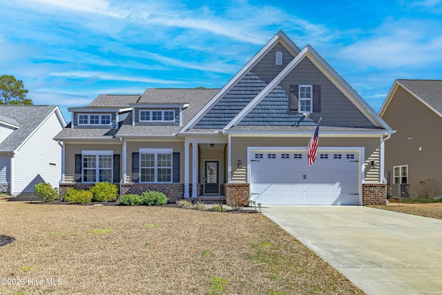 craftsman house with driveway, brick siding, and a front lawn