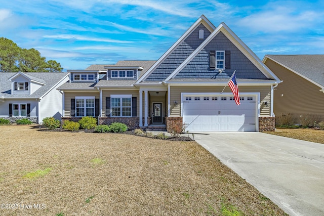 view of front of home featuring driveway, brick siding, an attached garage, and a front lawn