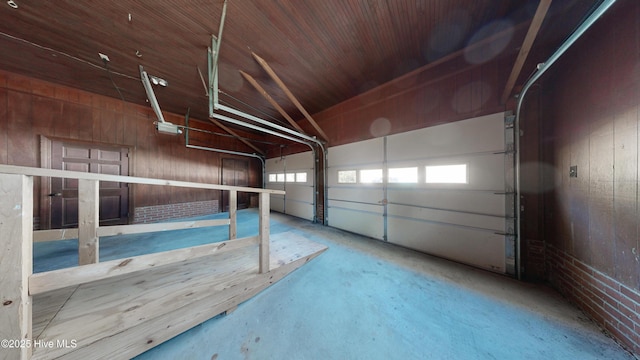 garage featuring wooden ceiling and wooden walls