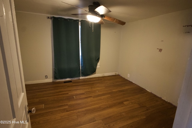 spare room with ceiling fan and wood finished floors