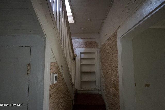 staircase with brick wall