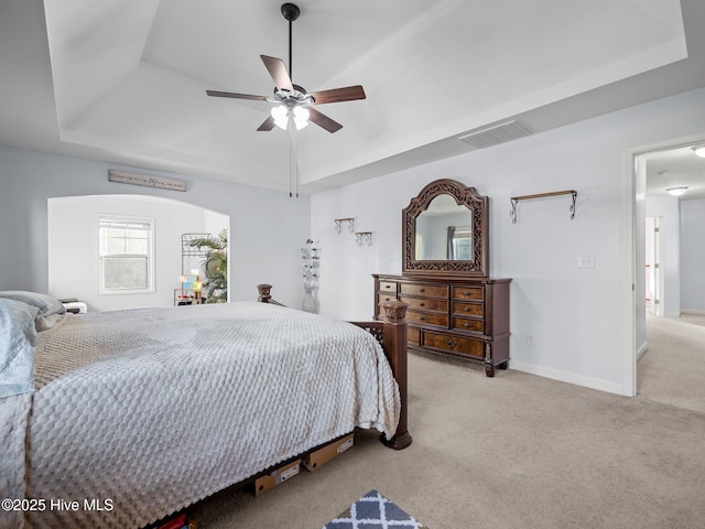 bedroom featuring visible vents, a raised ceiling, baseboards, and carpet flooring