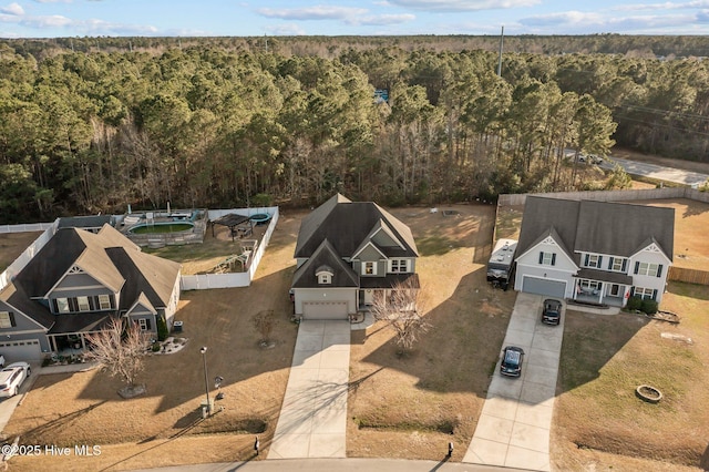 birds eye view of property featuring a wooded view