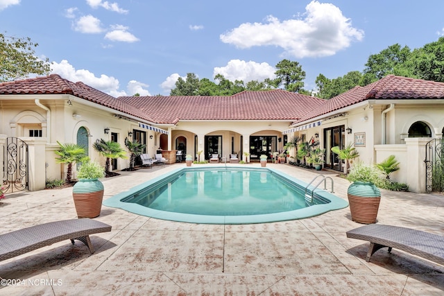 outdoor pool featuring a patio