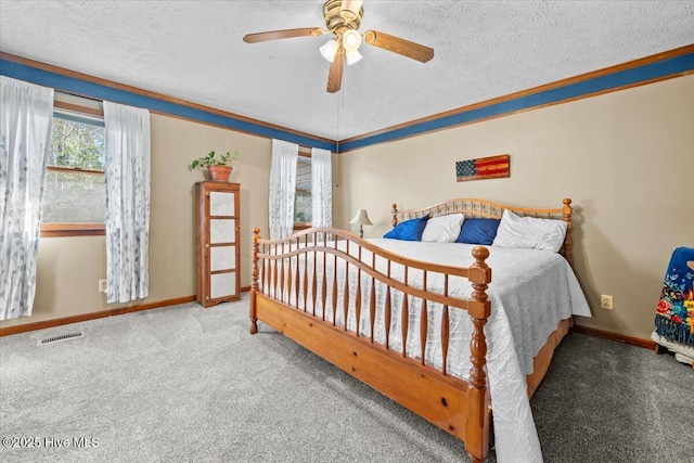 carpeted bedroom featuring a textured ceiling, visible vents, and baseboards