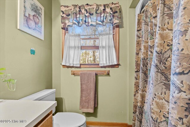 carpeted bedroom with a textured ceiling, baseboards, ornamental molding, and ceiling fan