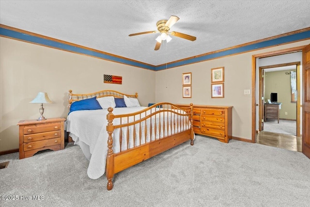 carpeted bedroom with a ceiling fan, crown molding, a textured ceiling, and baseboards