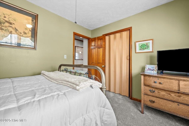 carpeted bedroom featuring a textured ceiling and a closet