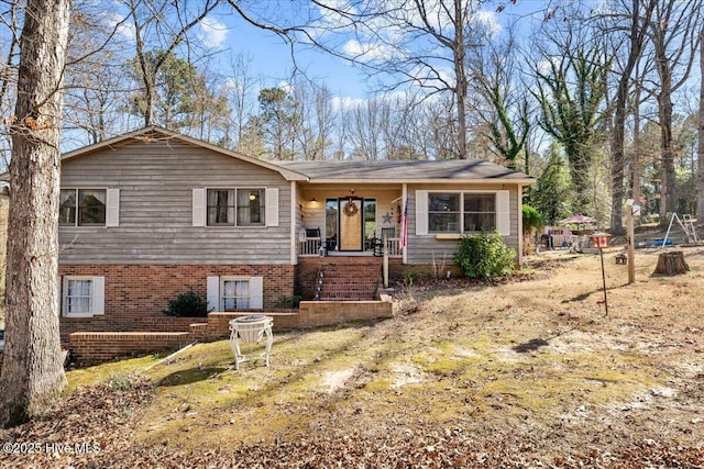 view of front of house with covered porch and brick siding