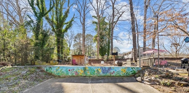 view of home's community with an outbuilding, a swimming pool, and a shed