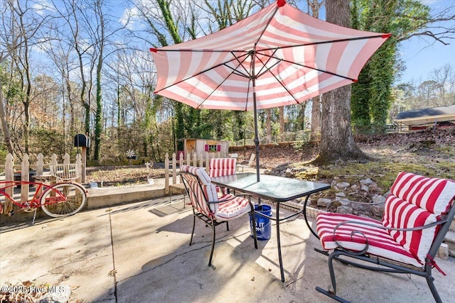 view of patio featuring outdoor dining area and an outdoor structure