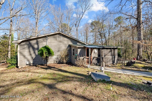 view of side of property with a lawn