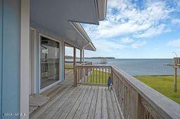 wooden deck featuring a water view