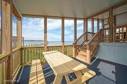 unfurnished sunroom with a water view