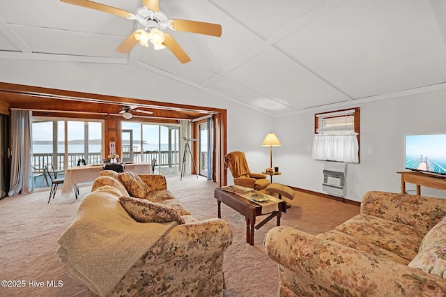 living area featuring baseboards, lofted ceiling, carpet flooring, heating unit, and a ceiling fan