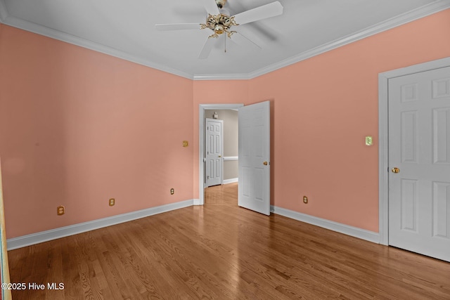 unfurnished bedroom featuring baseboards, ornamental molding, ceiling fan, and wood finished floors