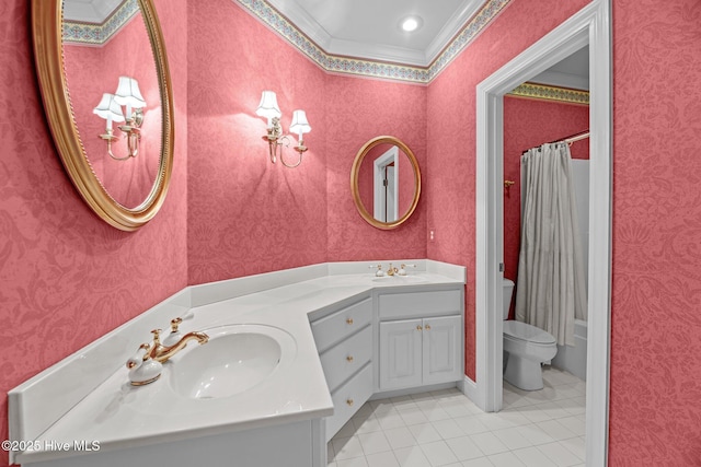 bathroom featuring toilet, wallpapered walls, double vanity, and a sink