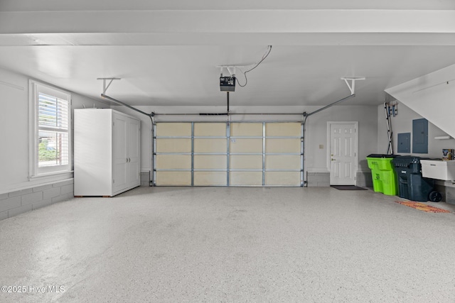 garage featuring a garage door opener and electric panel