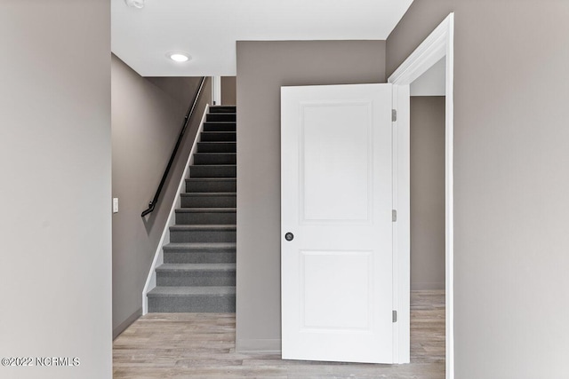 staircase with wood finished floors and baseboards
