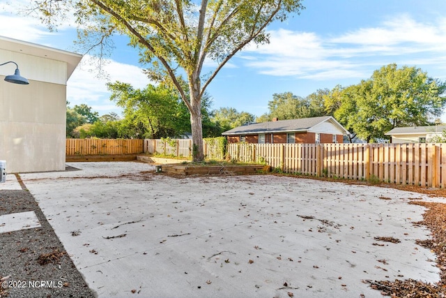view of yard featuring fence private yard, a patio area, and a garden