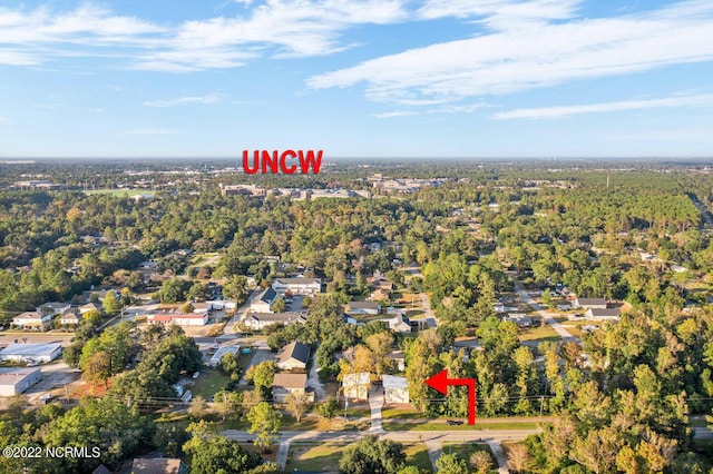 birds eye view of property with a view of trees