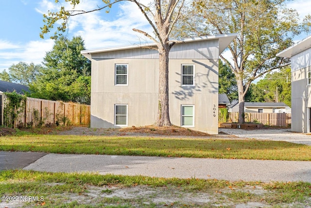 view of side of property featuring fence