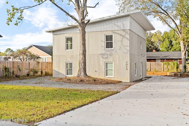 view of side of property with a yard and fence
