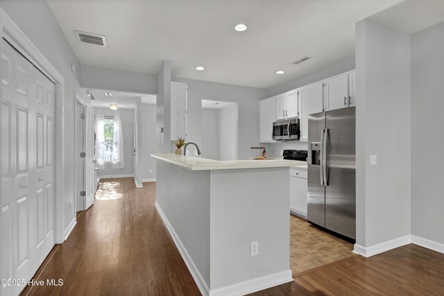 spare room featuring a healthy amount of sunlight, a notable chandelier, baseboards, and dark wood-style flooring