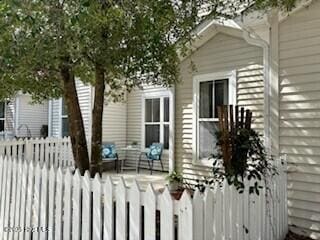 view of home's exterior featuring covered porch and fence