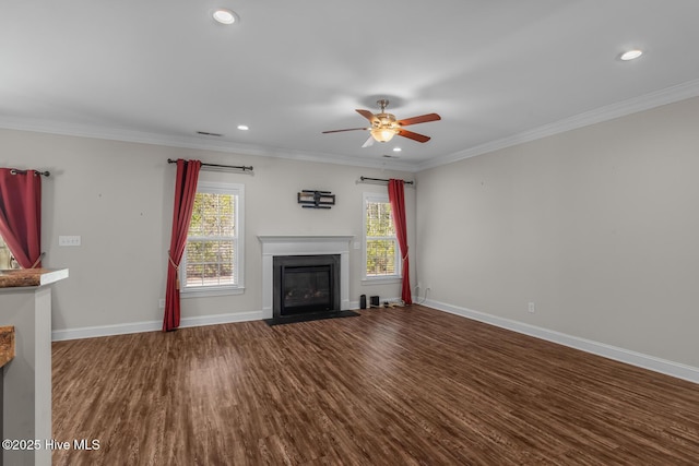 unfurnished living room featuring a fireplace with flush hearth, baseboards, dark wood-style flooring, and crown molding