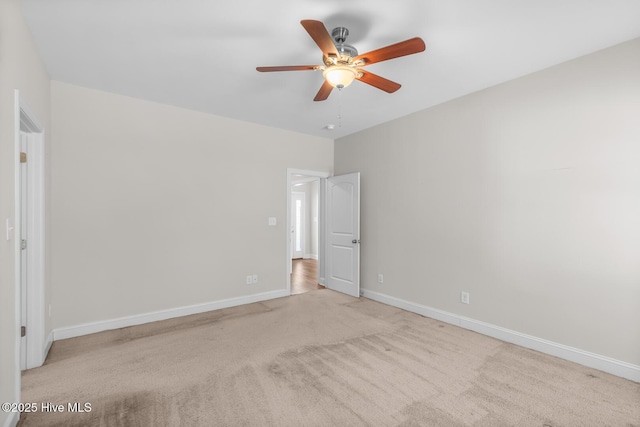 unfurnished bedroom featuring carpet floors, a ceiling fan, and baseboards