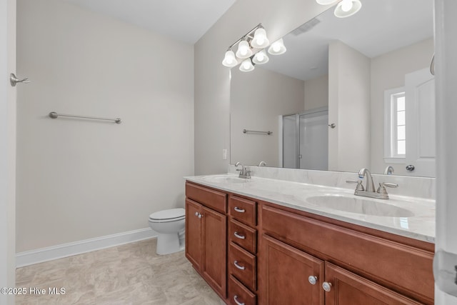 bathroom with double vanity, visible vents, an enclosed shower, and a sink