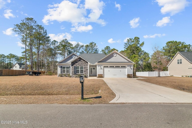 craftsman house featuring an attached garage, stone siding, fence, and concrete driveway