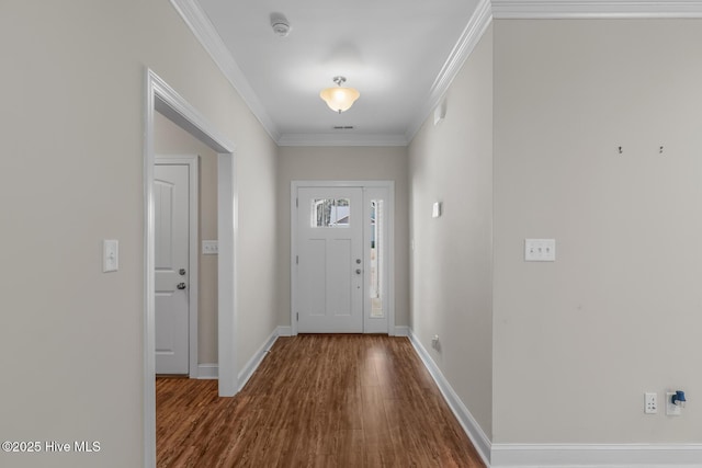 foyer entrance featuring baseboards, ornamental molding, and wood finished floors