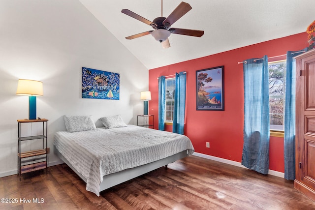 bedroom with ceiling fan, baseboards, vaulted ceiling, and wood finished floors