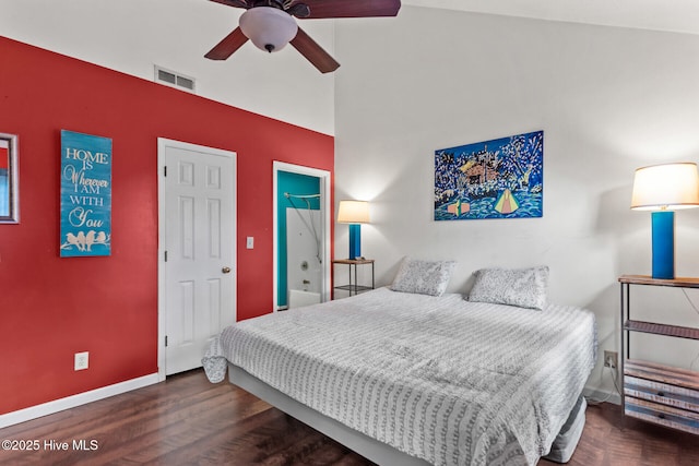 bedroom with baseboards, visible vents, a towering ceiling, ceiling fan, and wood finished floors