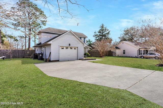 view of home's exterior with a garage, driveway, a lawn, and fence