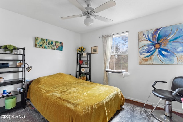 bedroom with ceiling fan and baseboards