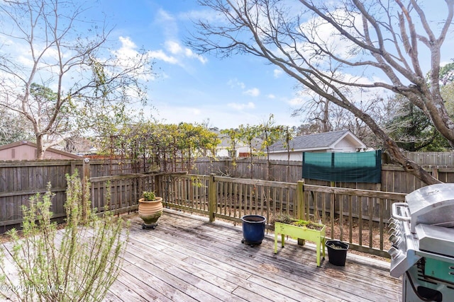 deck featuring a fenced backyard and a grill